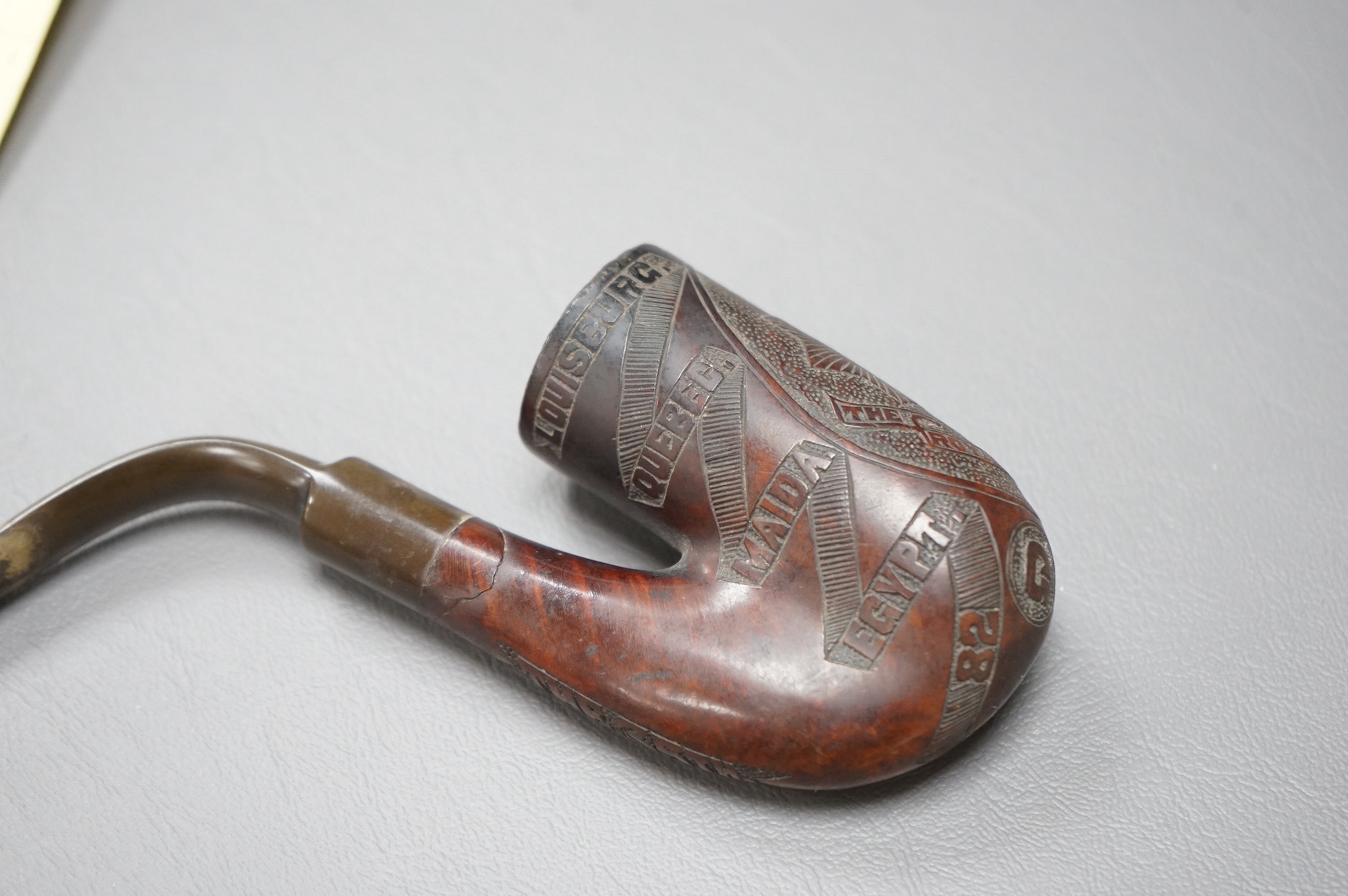 A briar and horn Boer War related smoker’s pipe, engraved with the crest for the 35th Royal Sussex regiment, together with a list of major battles and dated 1882 and 1900-02, with the initials GS to the base of the bowl.